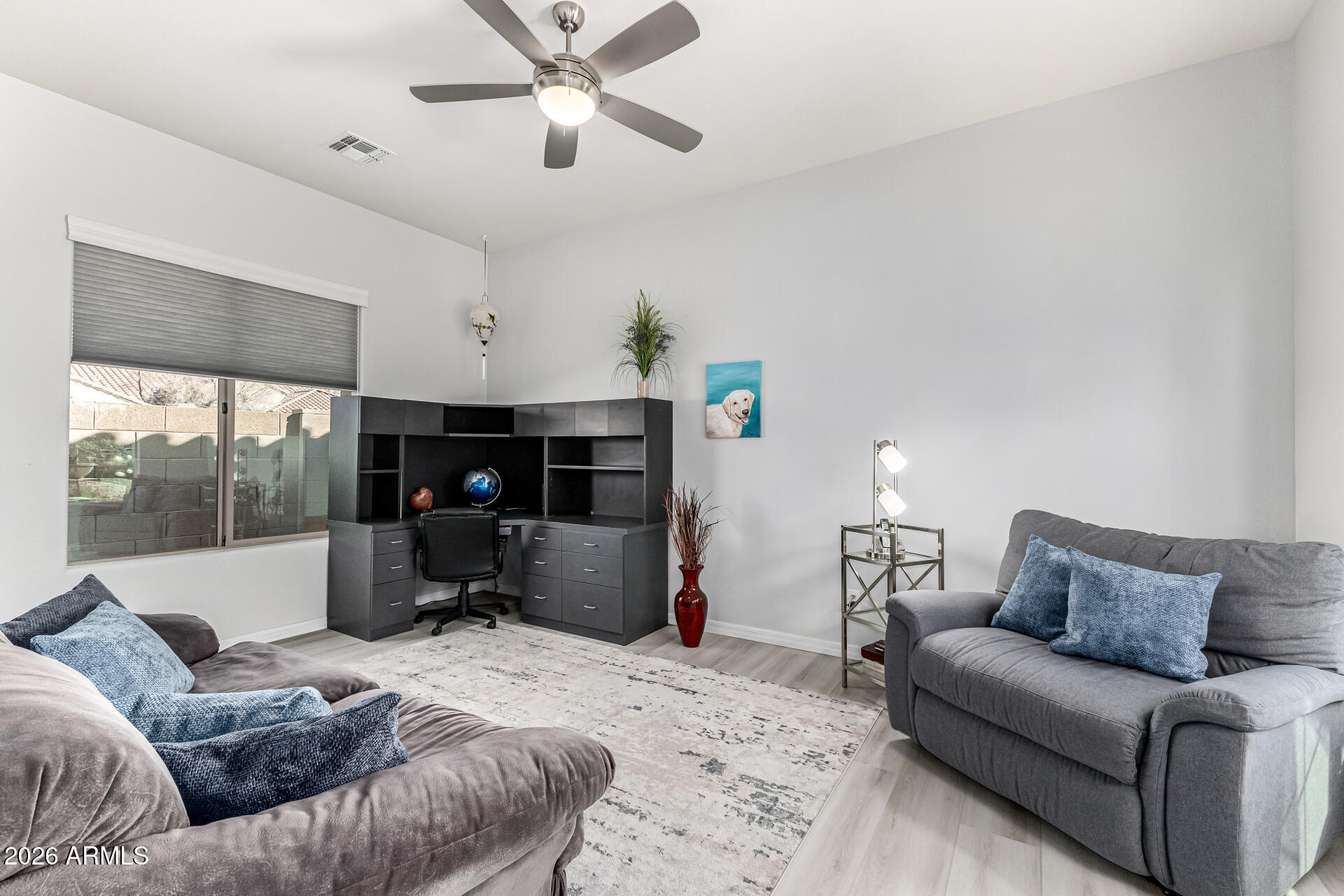 17926 West Griswold Road Waddell, AZ 85355 - Photo 28 of 73 a living room with furniture and a flat screen tv