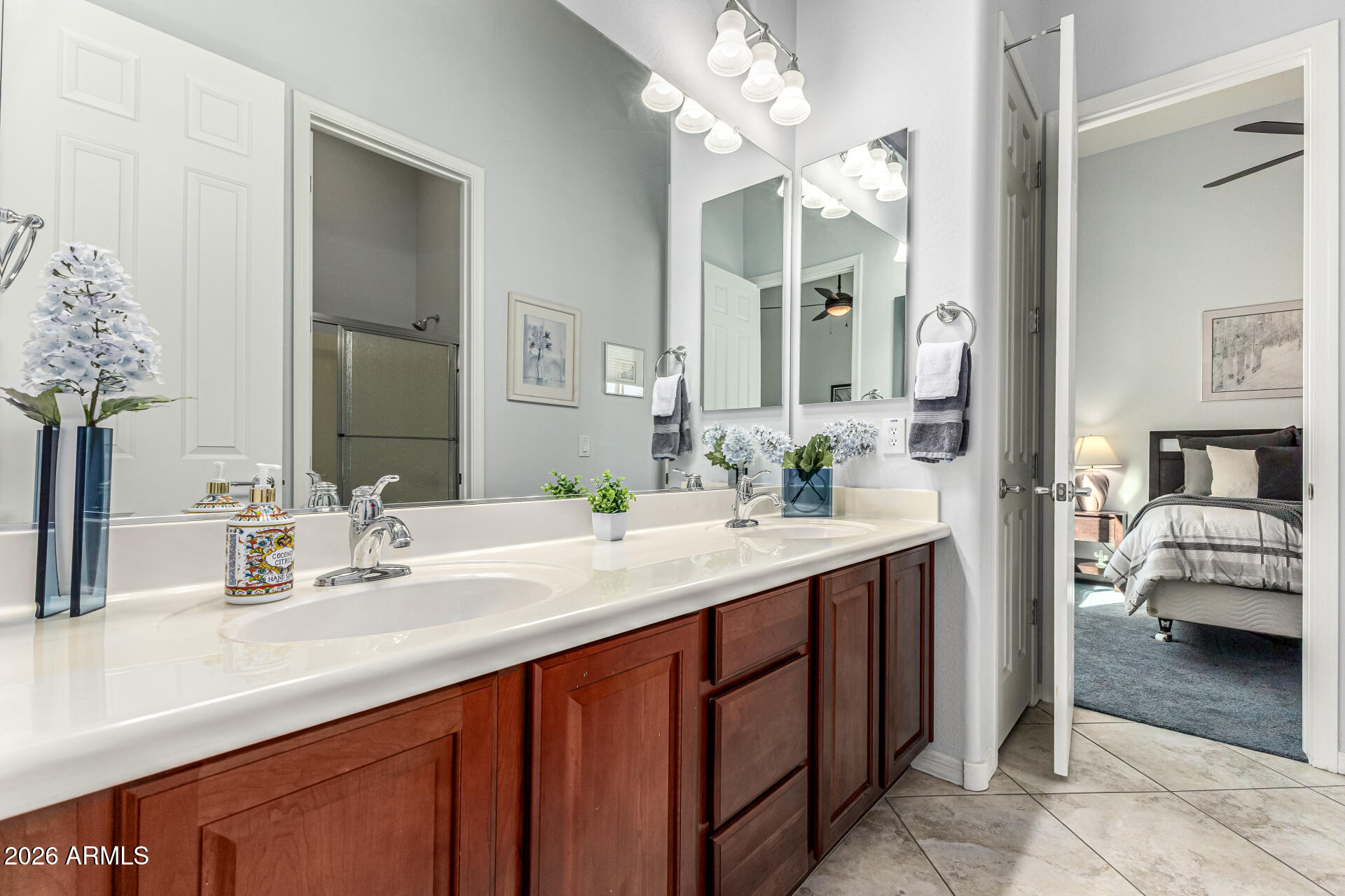 17926 West Griswold Road Waddell, AZ 85355 - Photo 33 of 73 a en suite bathroom with a sink and a mirror