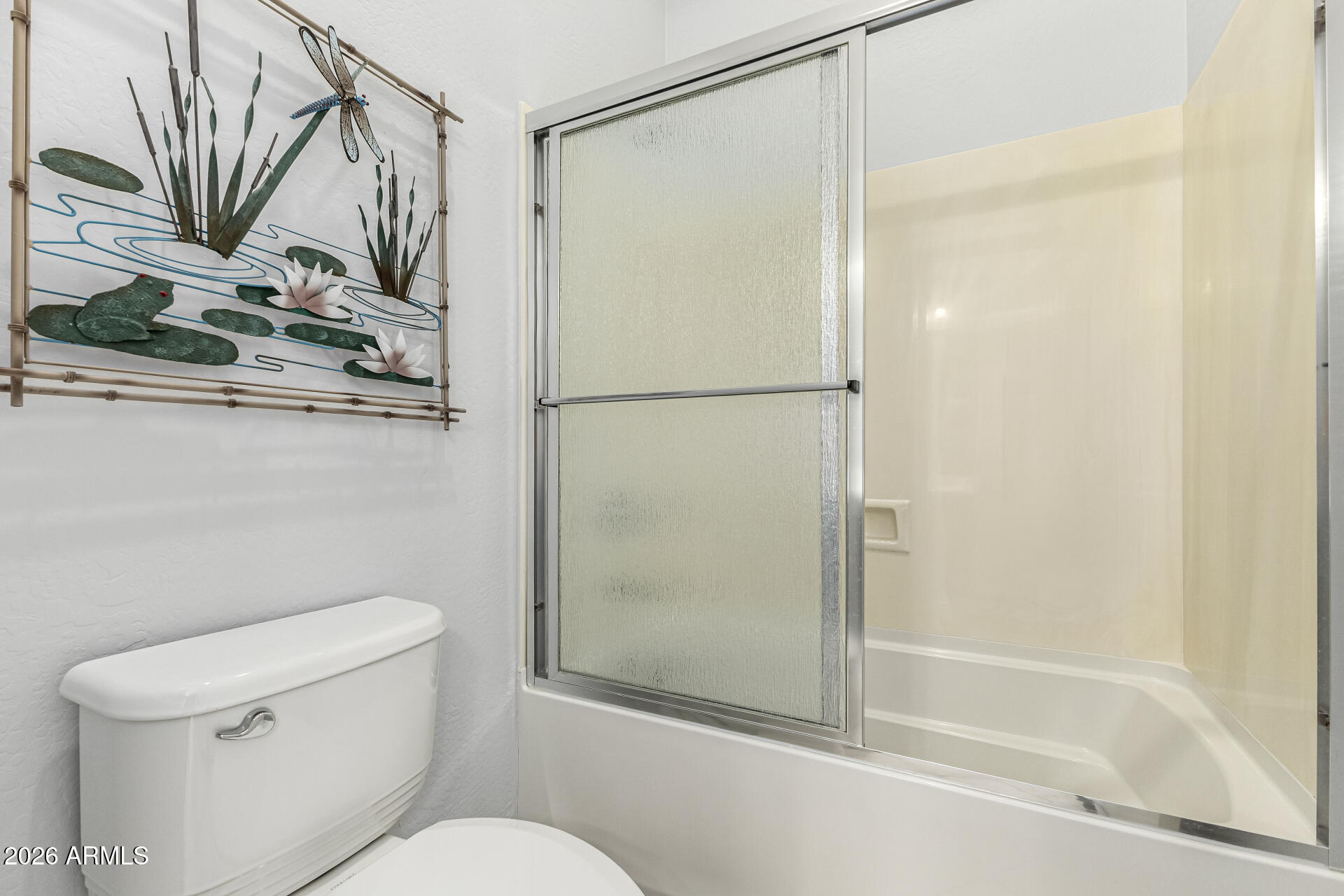 17926 West Griswold Road Waddell, AZ 85355 - Photo 34 of 73 a bathroom with a shower a toilet and a sink