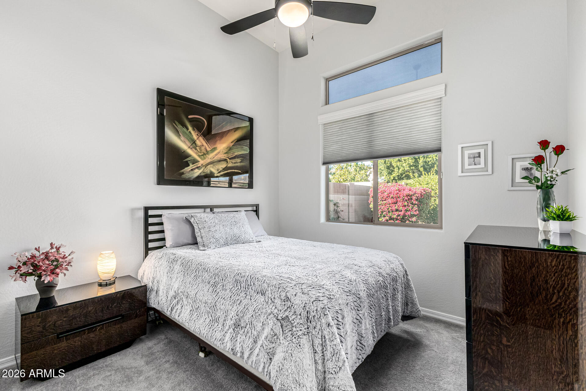 17926 West Griswold Road Waddell, AZ 85355 - Photo 37 of 73 a bedroom with a bed and a chandelier