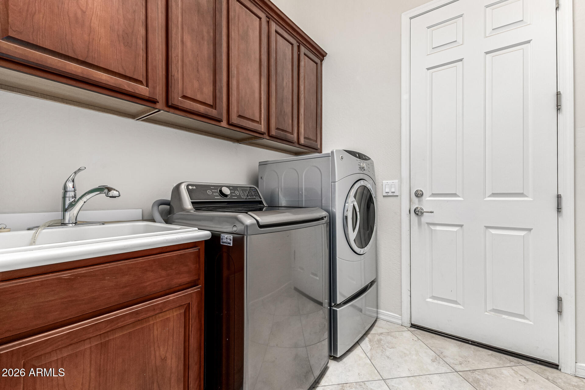 17926 West Griswold Road Waddell, AZ 85355 - Photo 40 of 73 a utility room with sink dryer and washer