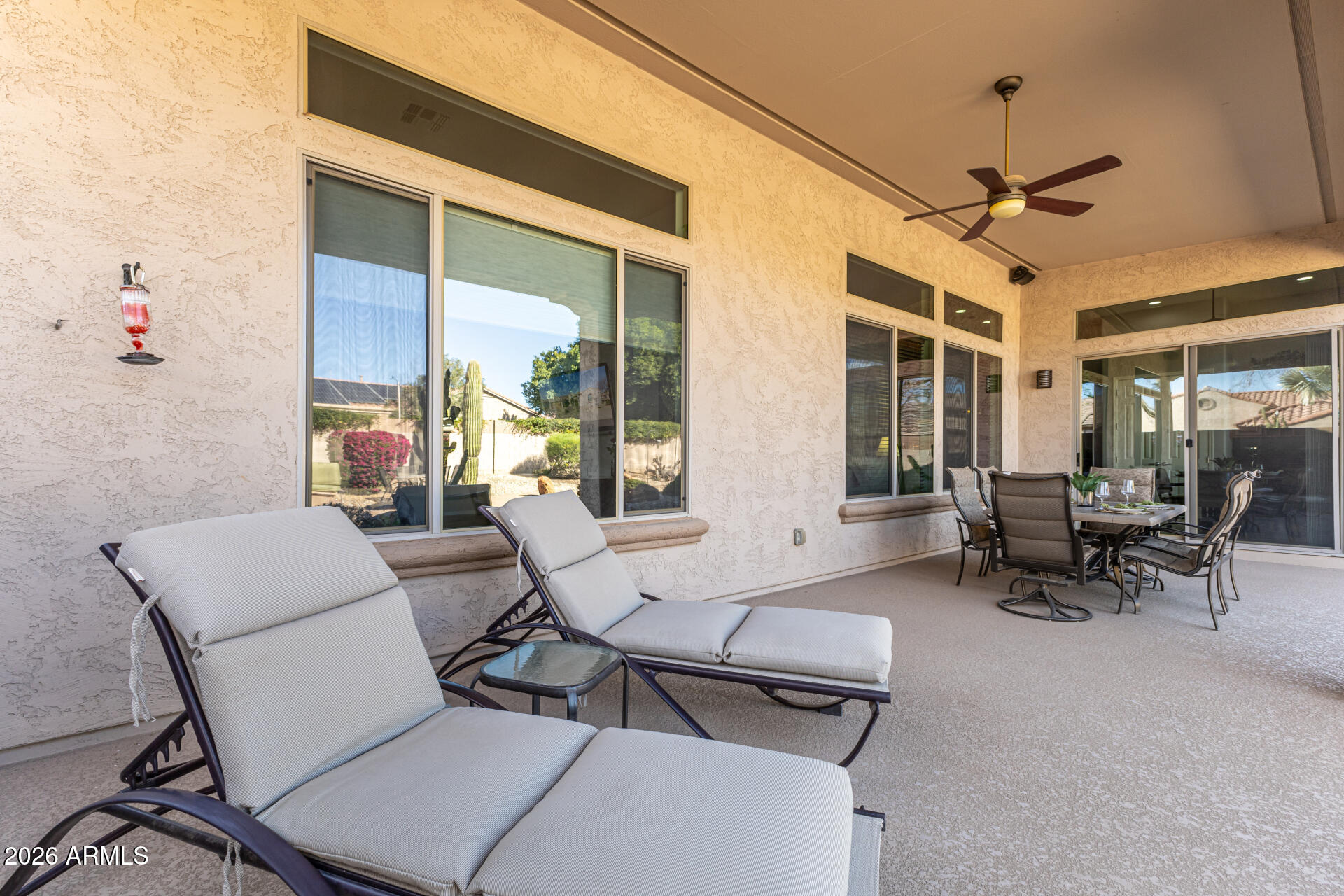 17926 West Griswold Road Waddell, AZ 85355 - Photo 47 of 73 a living room with furniture a flat screen tv and a large window