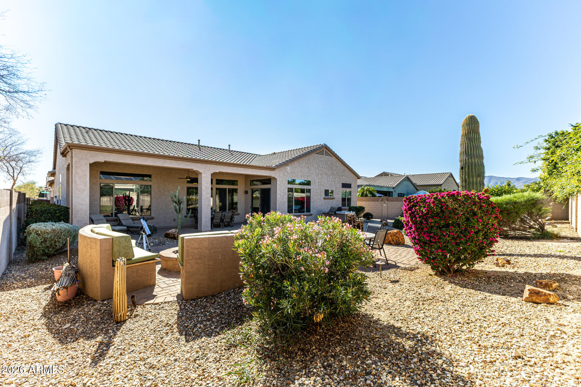 17926 West Griswold Road Waddell, AZ 85355 - Photo 51 of 73 a very nice looking house with a large window and potted plants