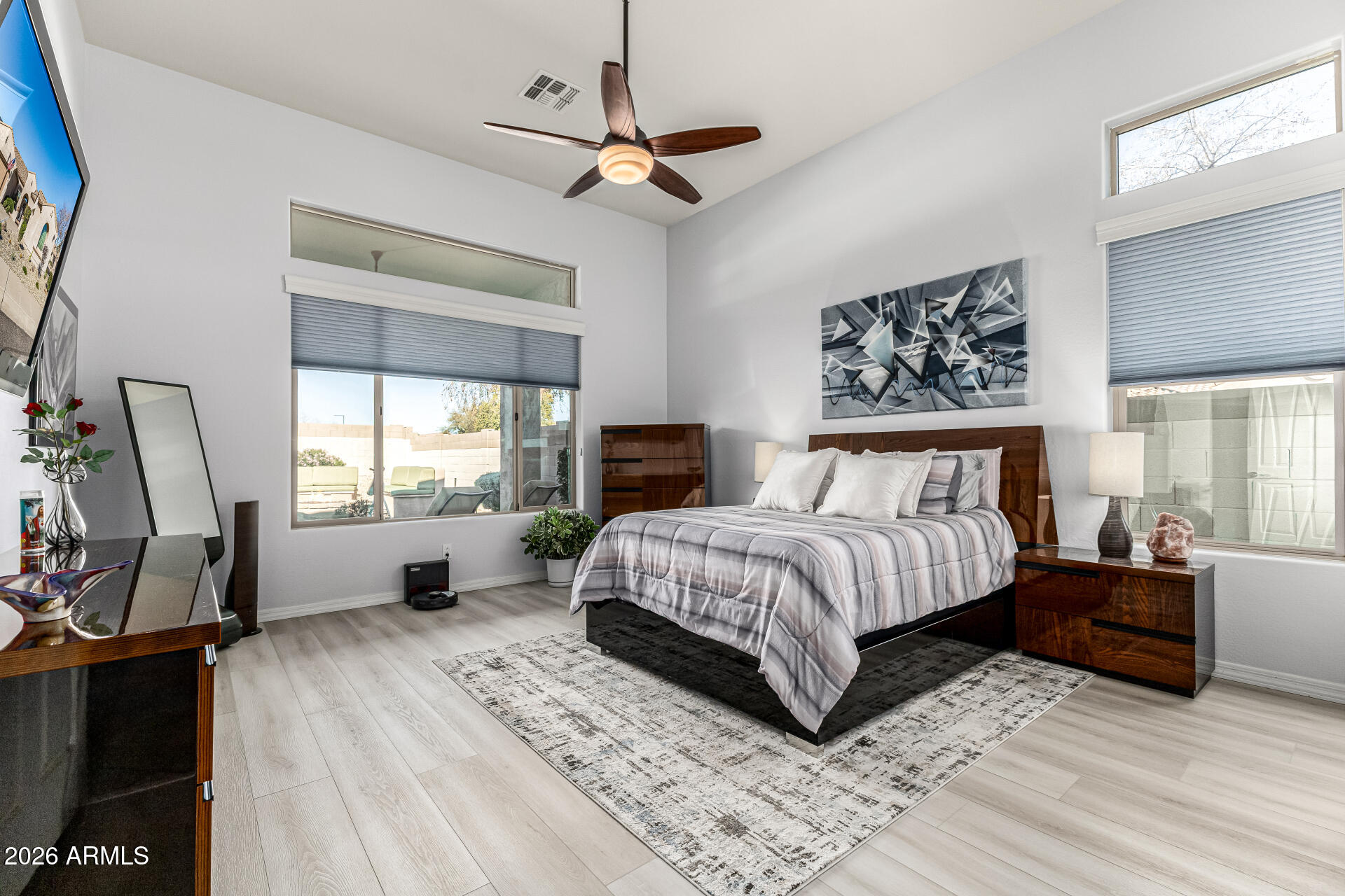 17926 West Griswold Road Waddell, AZ 85355 - Photo 8 of 73 a bedroom with a bed a couch and dresser