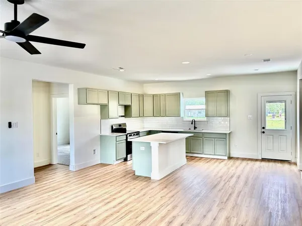 a kitchen with a sink and a refrigerator