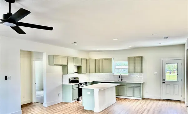 a kitchen with stainless steel appliances a stove a refrigerator and a refrigerator