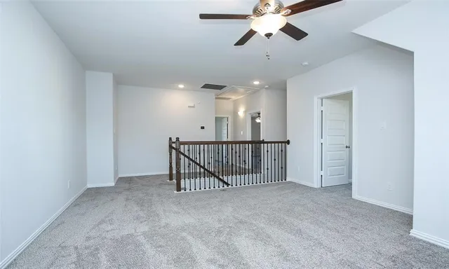 a view of a hallway with a ceiling fan