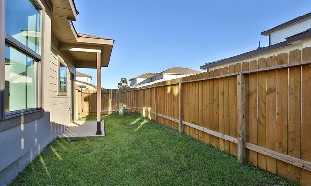 a backyard of a house with table and chairs