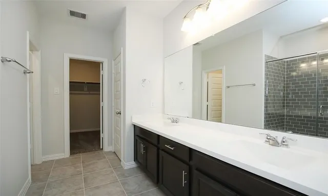 a bathroom with a double vanity sink mirror and double