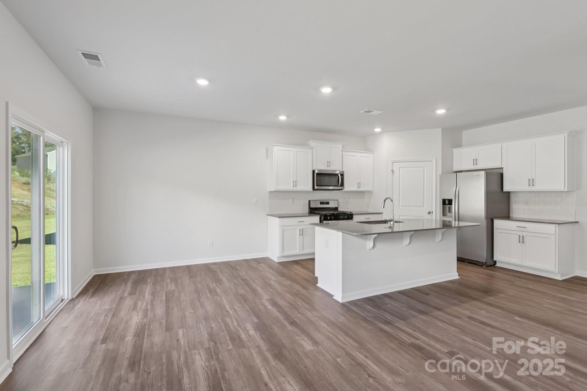 3964 Ashton Drive Northwest Conover, NC 28613 - Photo 12 of 44 a kitchen with a refrigerator and white cabinets