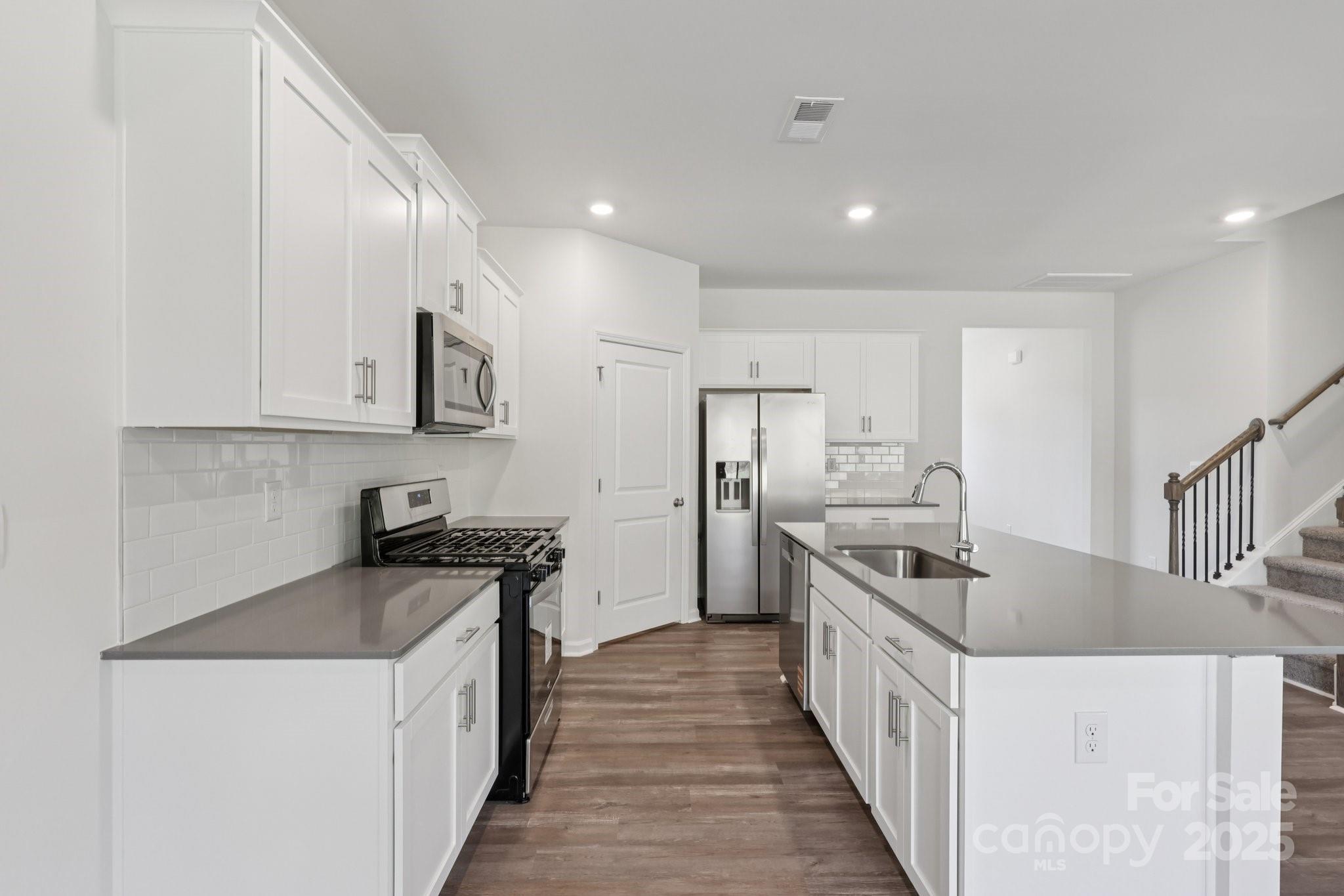 3964 Ashton Drive Northwest Conover, NC 28613 - Photo 13 of 44 a kitchen with stainless steel appliances granite countertop a sink stove and refrigerator
