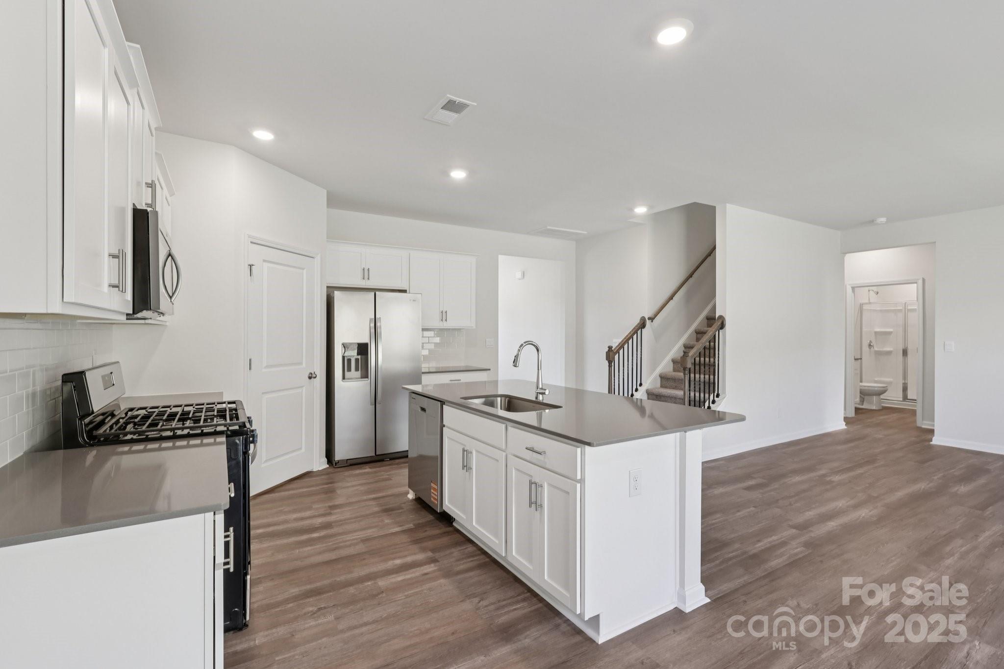 3964 Ashton Drive Northwest Conover, NC 28613 - Photo 14 of 44 a kitchen with stainless steel appliances granite countertop a stove and a refrigerator