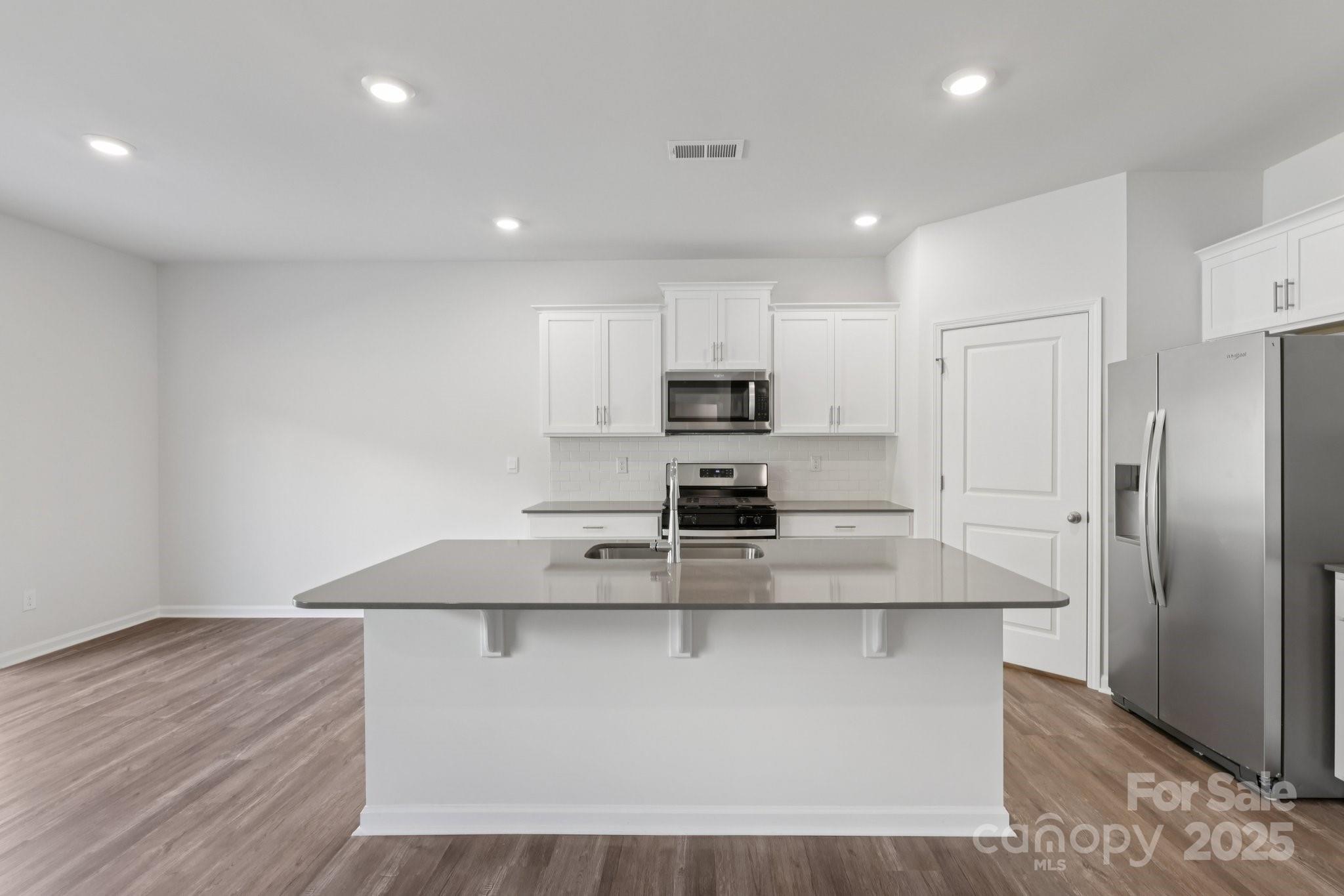3964 Ashton Drive Northwest Conover, NC 28613 - Photo 18 of 44 a kitchen with kitchen island white cabinets and stainless steel appliances