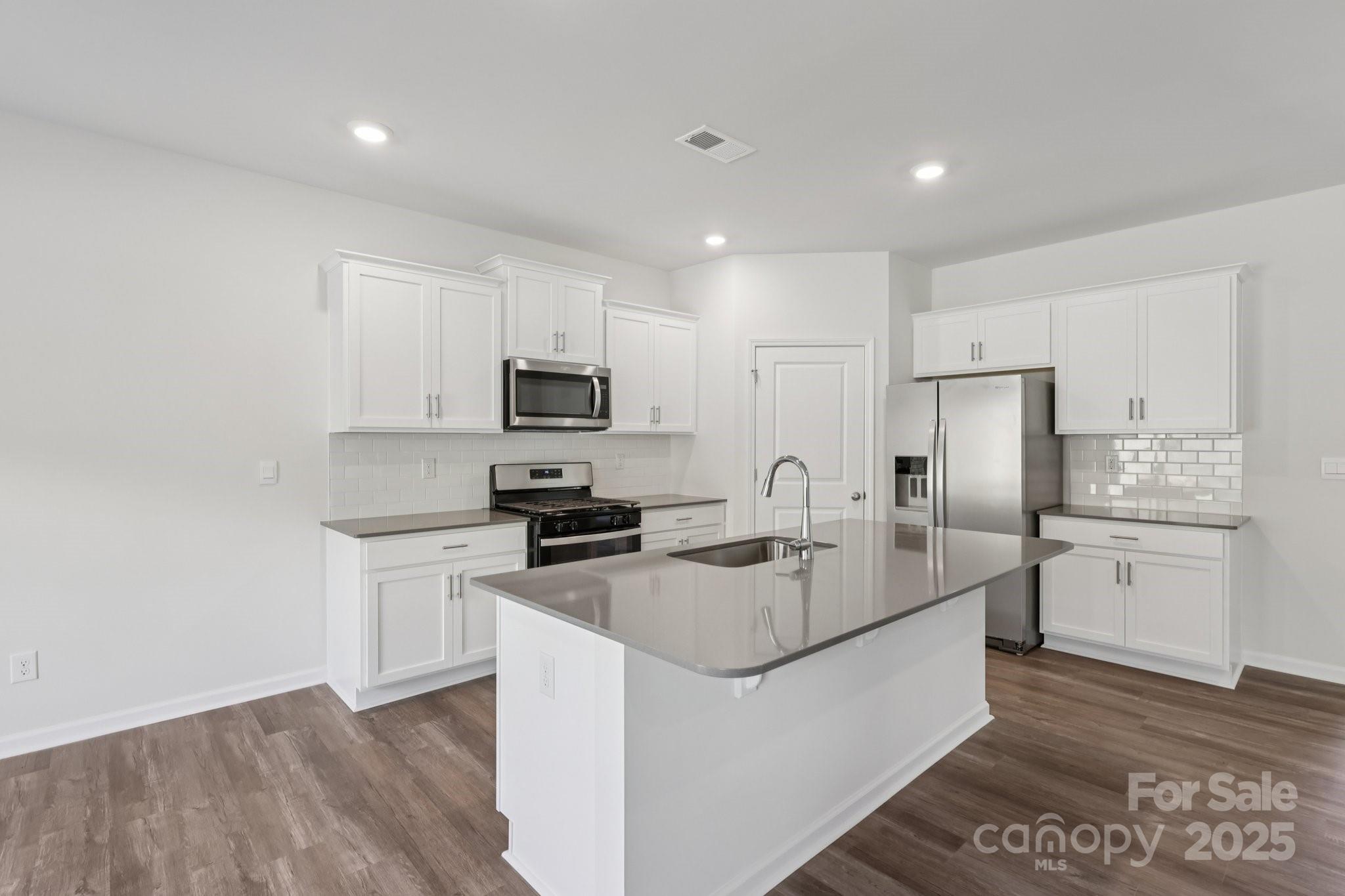 3964 Ashton Drive Northwest Conover, NC 28613 - Photo 19 of 44 a kitchen with refrigerator a sink and wooden cabinets