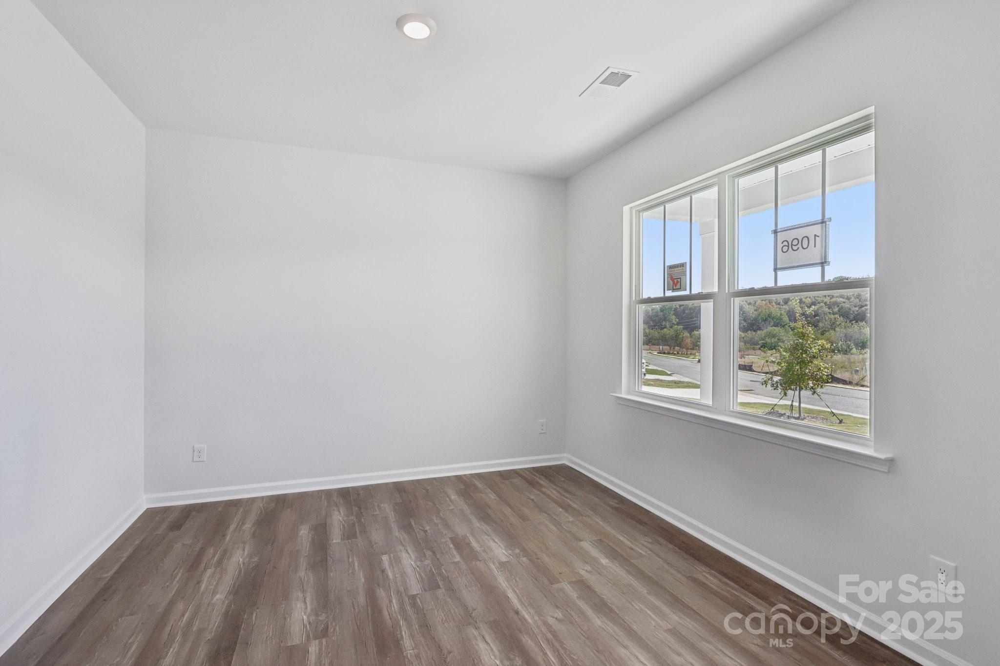 3964 Ashton Drive Northwest Conover, NC 28613 - Photo 20 of 44 an empty room with wooden floor and windows