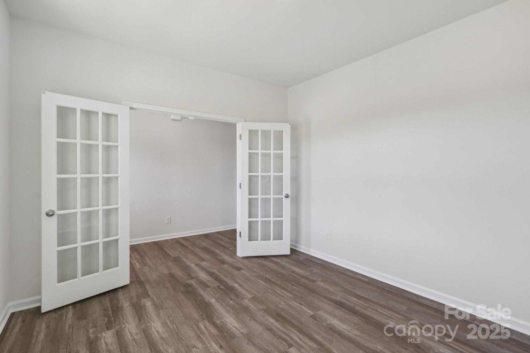 3964 Ashton Drive Northwest Conover, NC 28613 - Photo 22 of 44 an empty room with wooden floor and windows