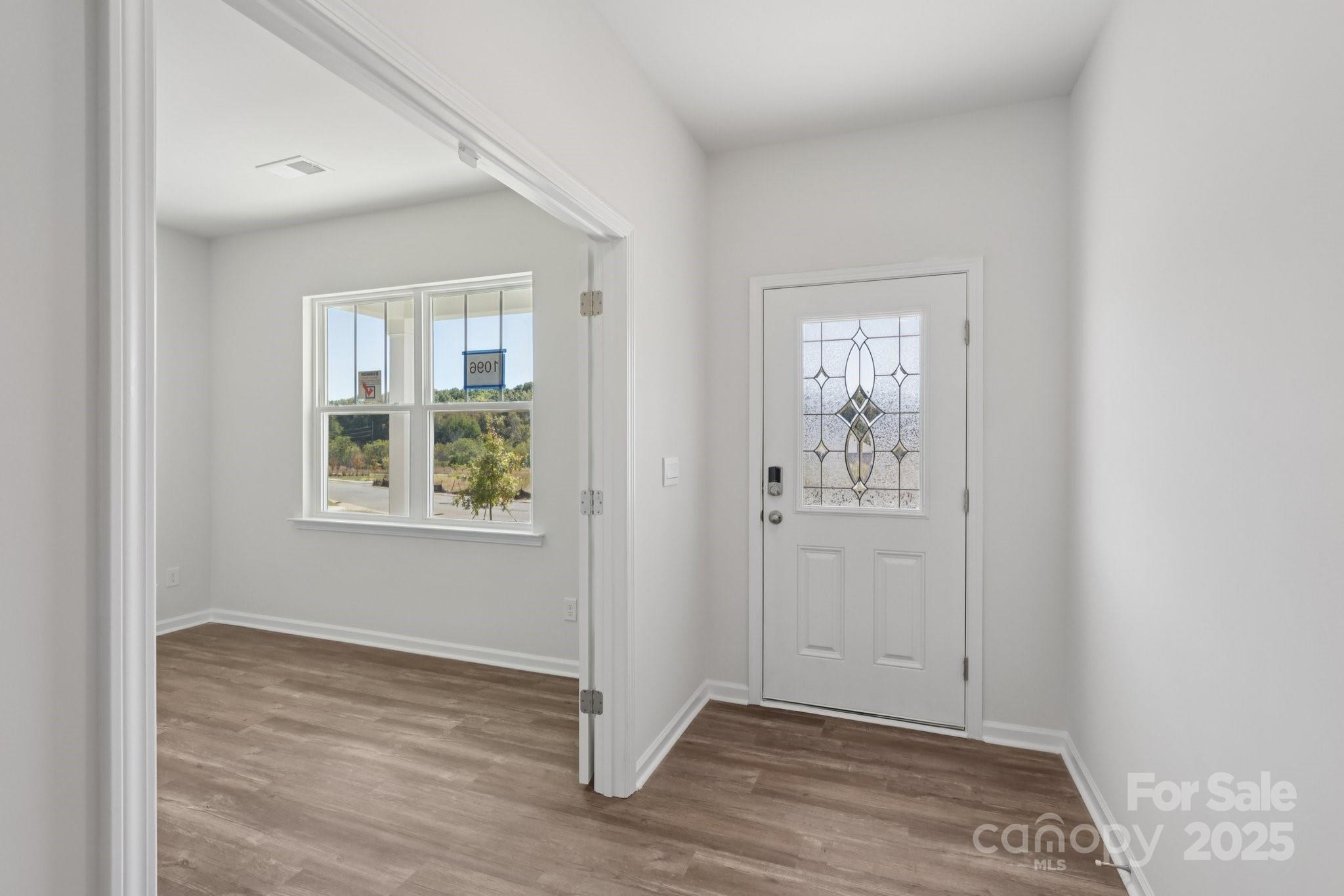 3964 Ashton Drive Northwest Conover, NC 28613 - Photo 4 of 44 a view of an empty room with window and wooden floor