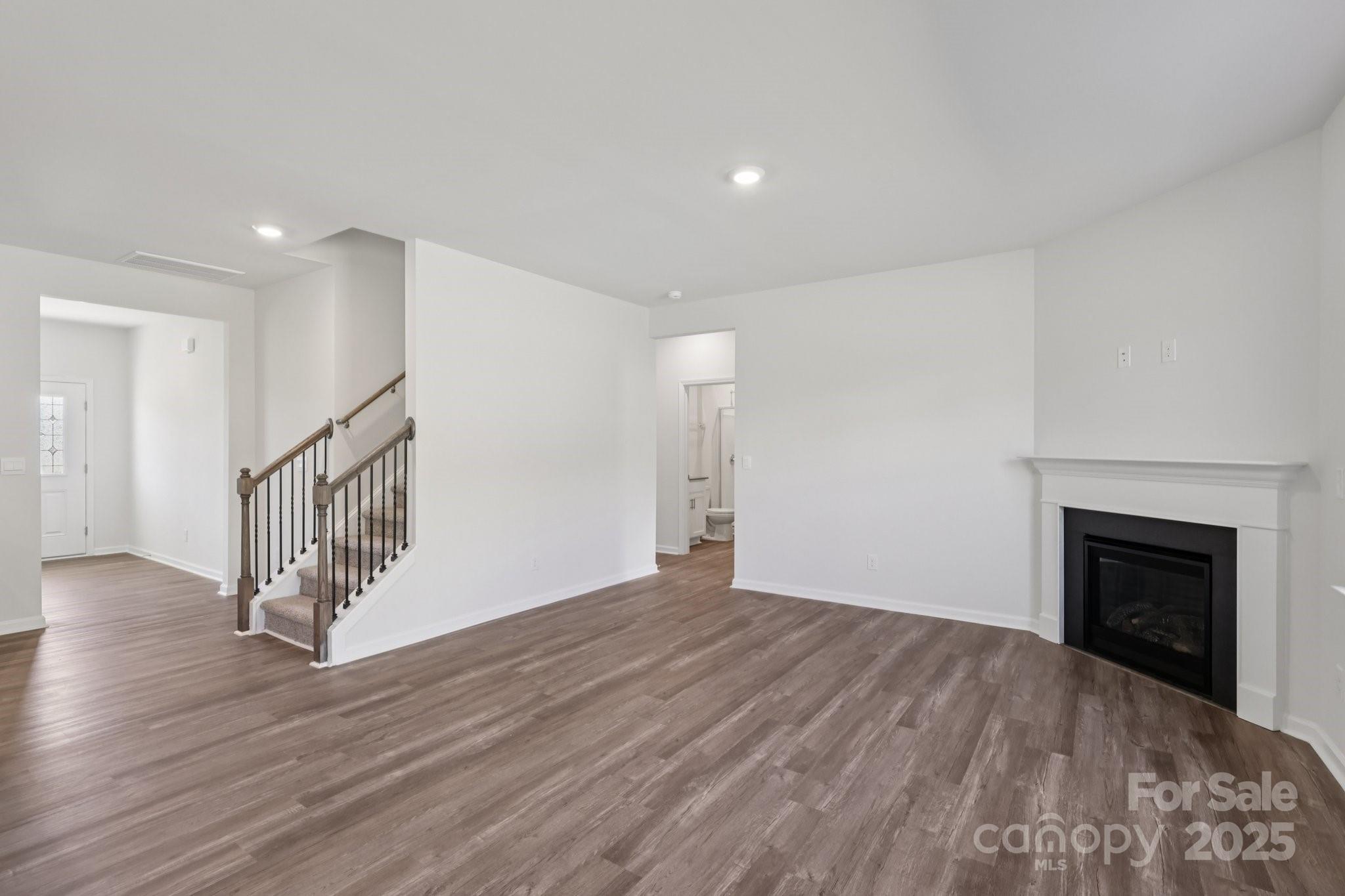 3964 Ashton Drive Northwest Conover, NC 28613 - Photo 5 of 44 a view of an empty room with wooden floor a fireplace and a window