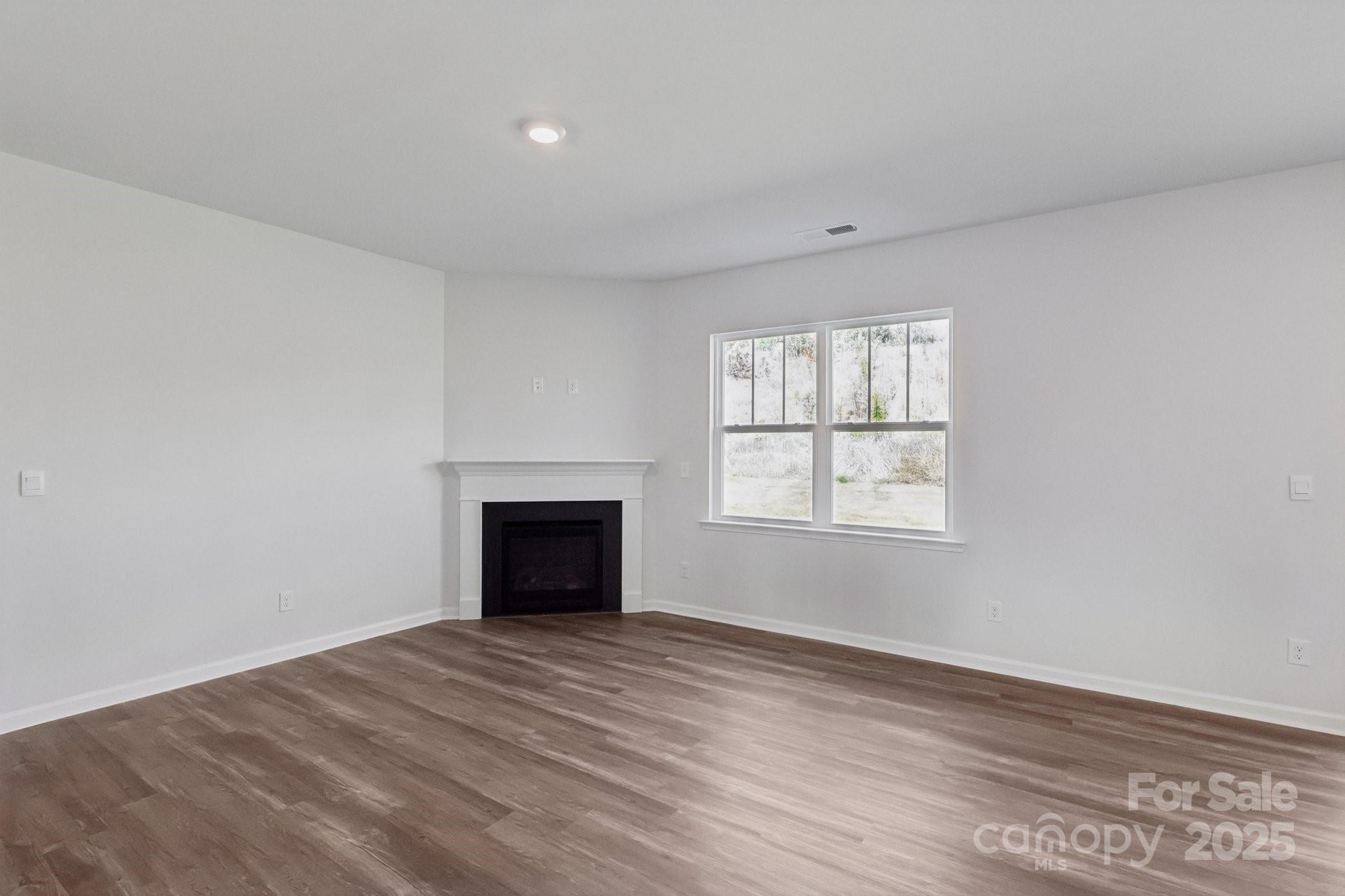 3964 Ashton Drive Northwest Conover, NC 28613 - Photo 6 of 44 wooden floor fireplace and windows in an empty room