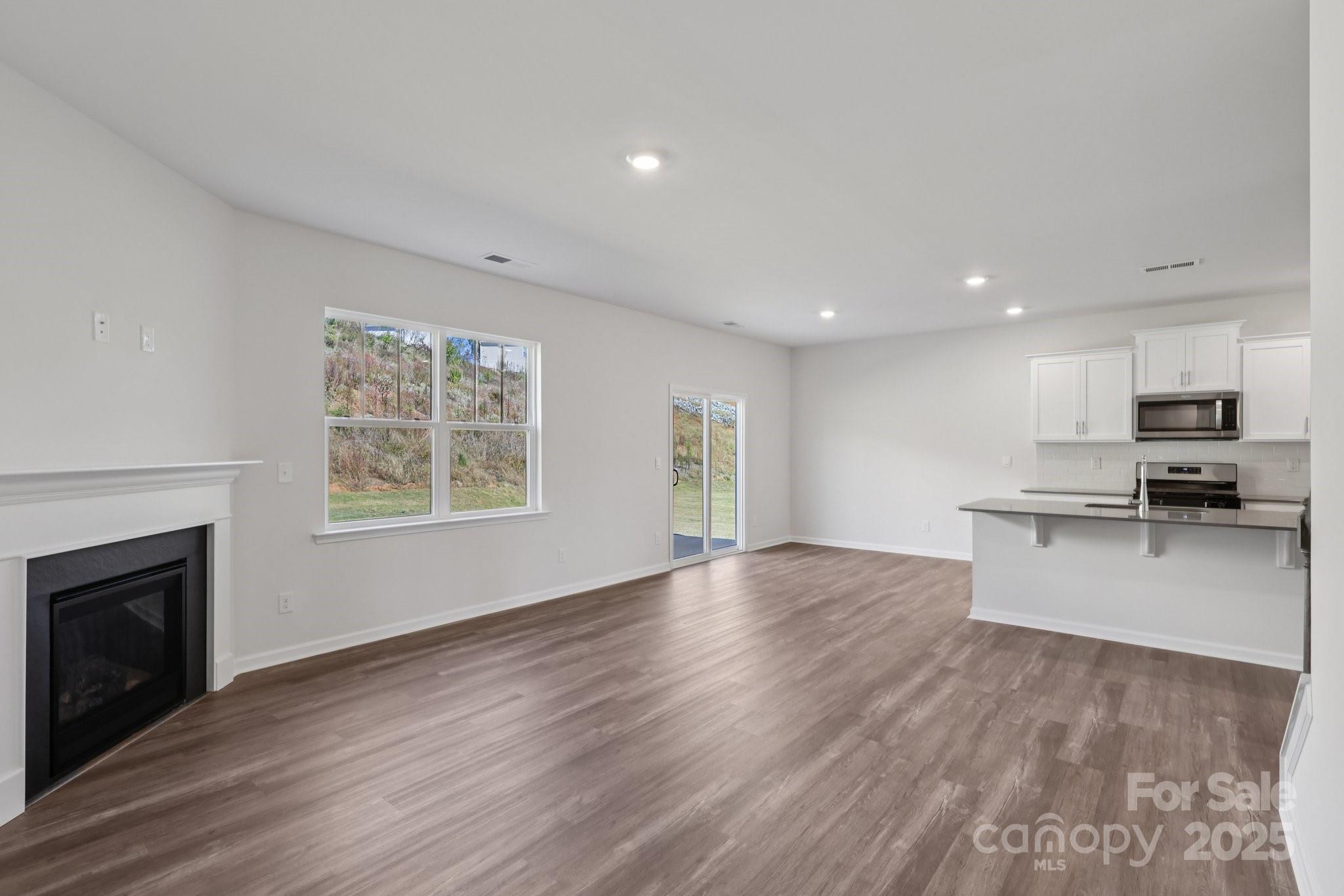 3964 Ashton Drive Northwest Conover, NC 28613 - Photo 7 of 44 a view of kitchen with microwave a stove and wooden floor