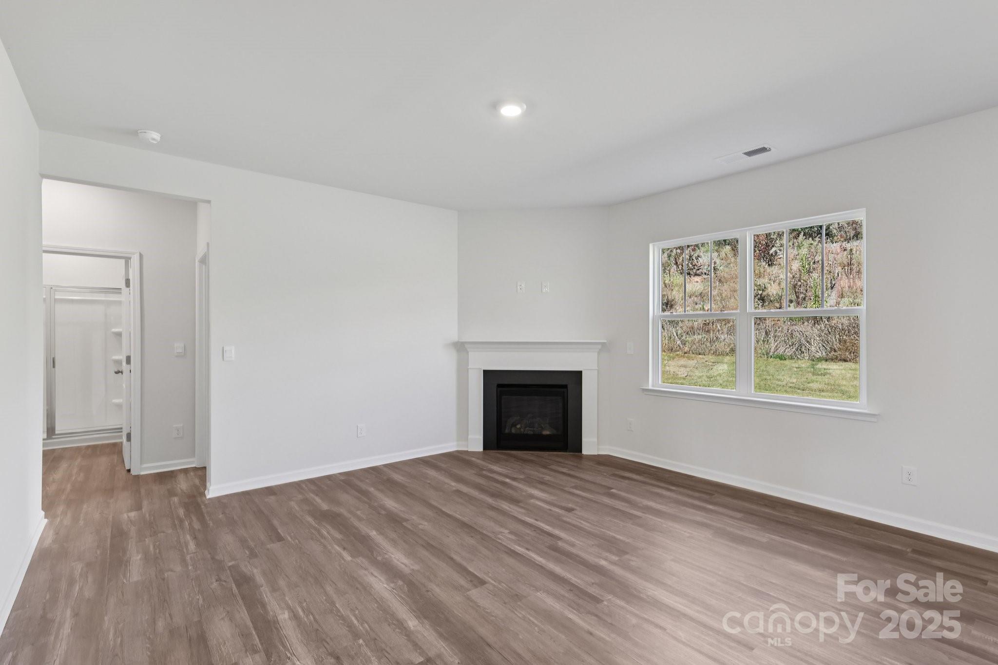 3964 Ashton Drive Northwest Conover, NC 28613 - Photo 8 of 44 a view of empty room with wooden floor and fireplace