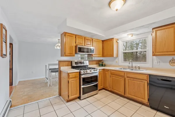 a kitchen with stainless steel appliances granite countertop a stove sink and cabinets