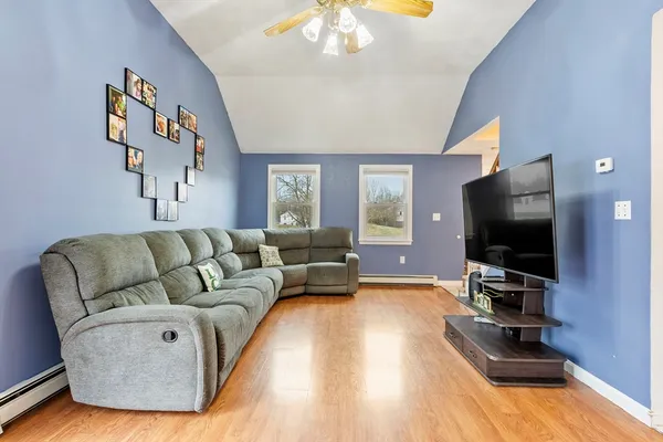 a living room with furniture and a flat screen tv
