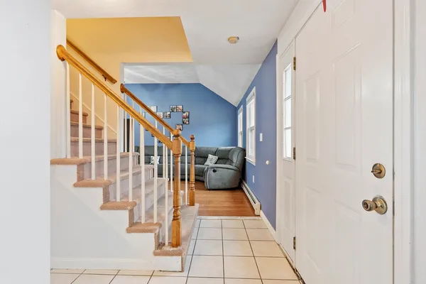 a view of a hallway with wooden floor and entryway