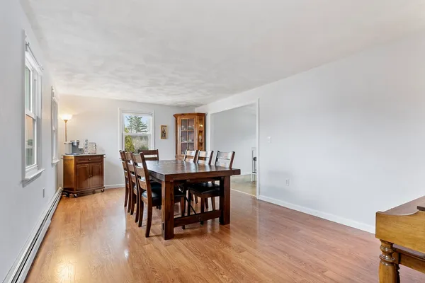 a view of a dining room with furniture and wooden floor