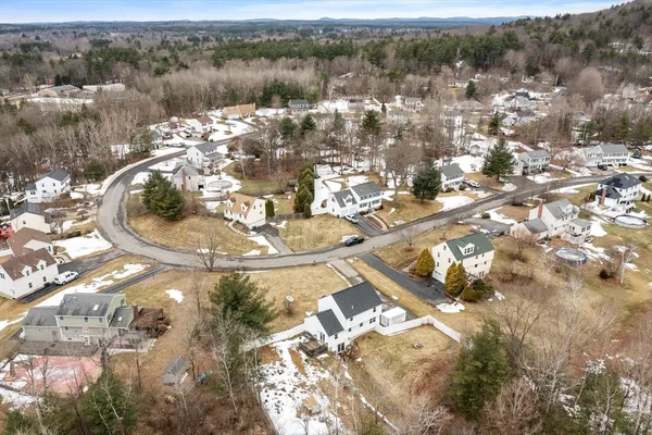 an aerial view of a residential houses with city view