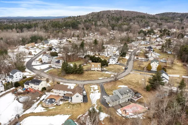 an aerial view of a house with a yard