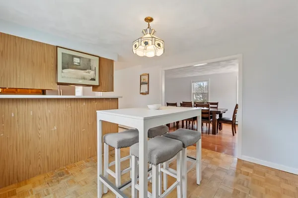 a view of a dining room with furniture and a chandelier