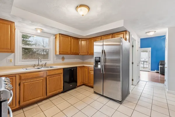 a kitchen with stainless steel appliances granite countertop a refrigerator a sink a stove and island