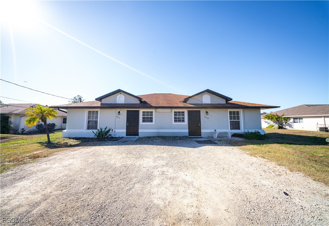 4519 25th Street Southwest Lehigh Acres, FL 33973 - Photo 1 of 24 a front view of a house with a yard and garage