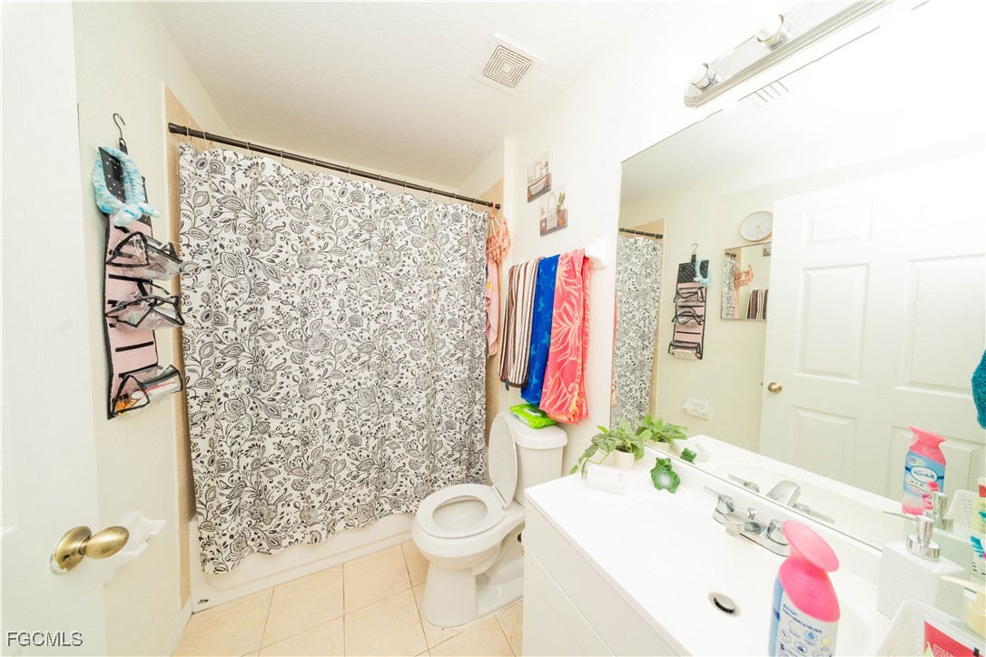 4519 25th Street Southwest Lehigh Acres, FL 33973 - Photo 13 of 24 a bathroom with a sink toilet and shower