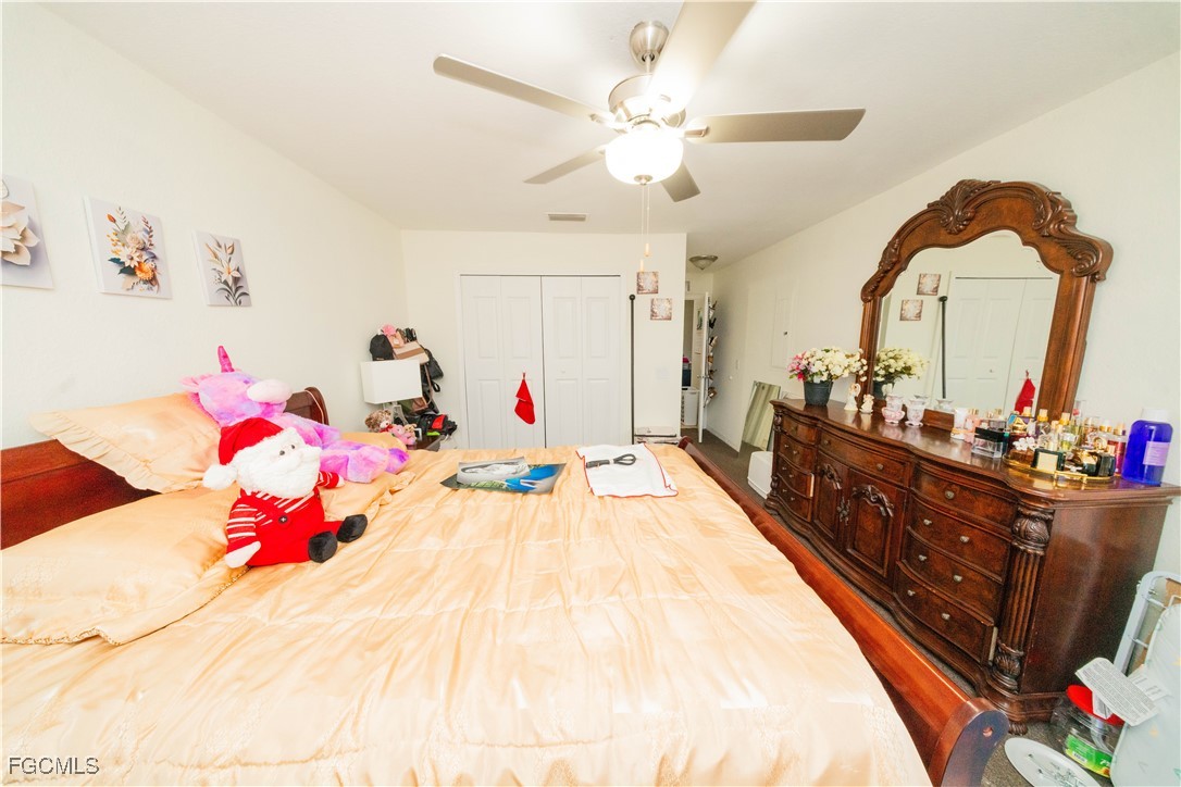 4519 25th Street Southwest Lehigh Acres, FL 33973 - Photo 14 of 24 a bed room with a bed mirror and a dresser