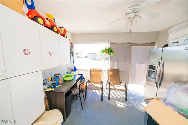 a dining room with furniture a kitchen view and a chandelier