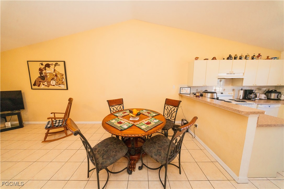 4519 25th Street Southwest Lehigh Acres, FL 33973 - Photo 18 of 24 a dining room with furniture and a floor to ceiling window