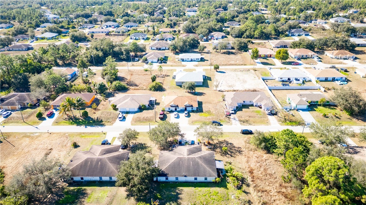 4519 25th Street Southwest Lehigh Acres, FL 33973 - Photo 24 of 24 an aerial view of residential houses with outdoor space and swimming pool