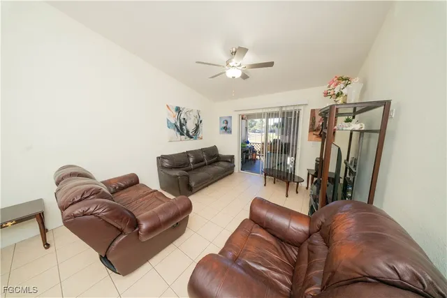 a living room with furniture ceiling fan and a rug