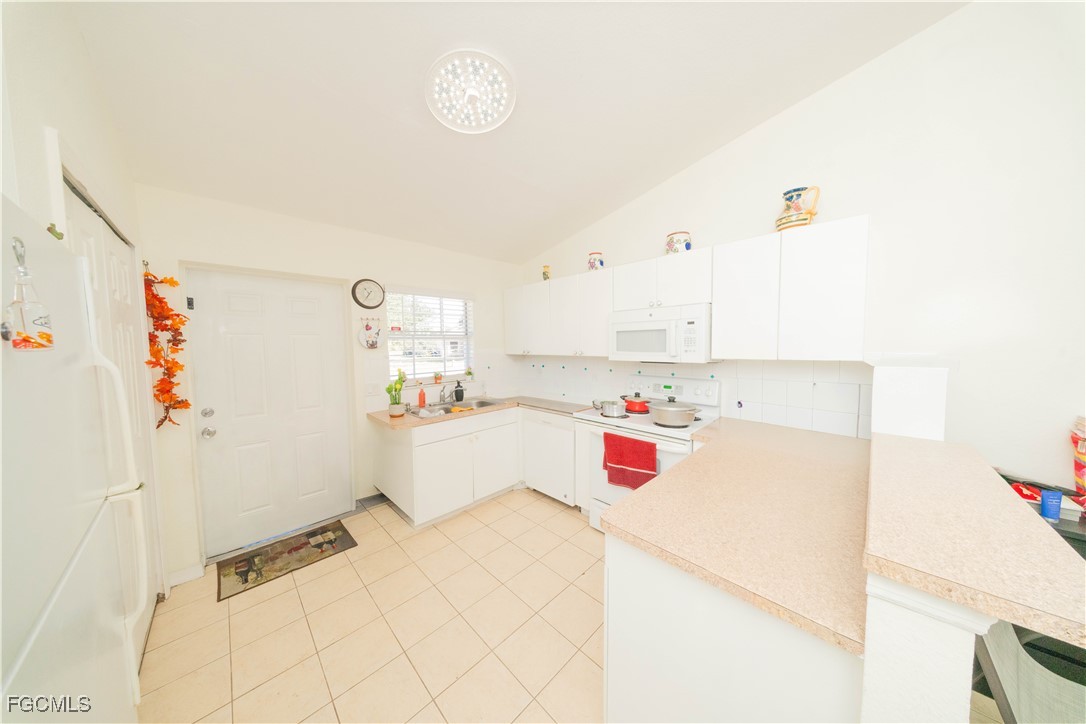 4519 25th Street Southwest Lehigh Acres, FL 33973 - Photo 5 of 24 a bedroom with a bed and cabinets