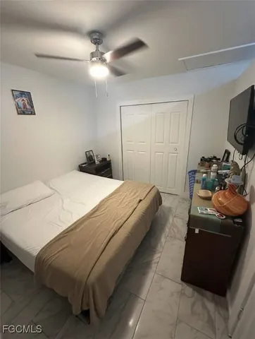 a bedroom with a bed and a tv