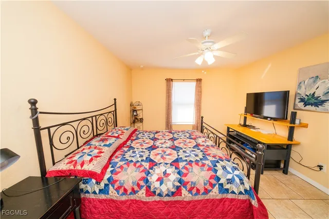 a bedroom with a bed and flat screen tv