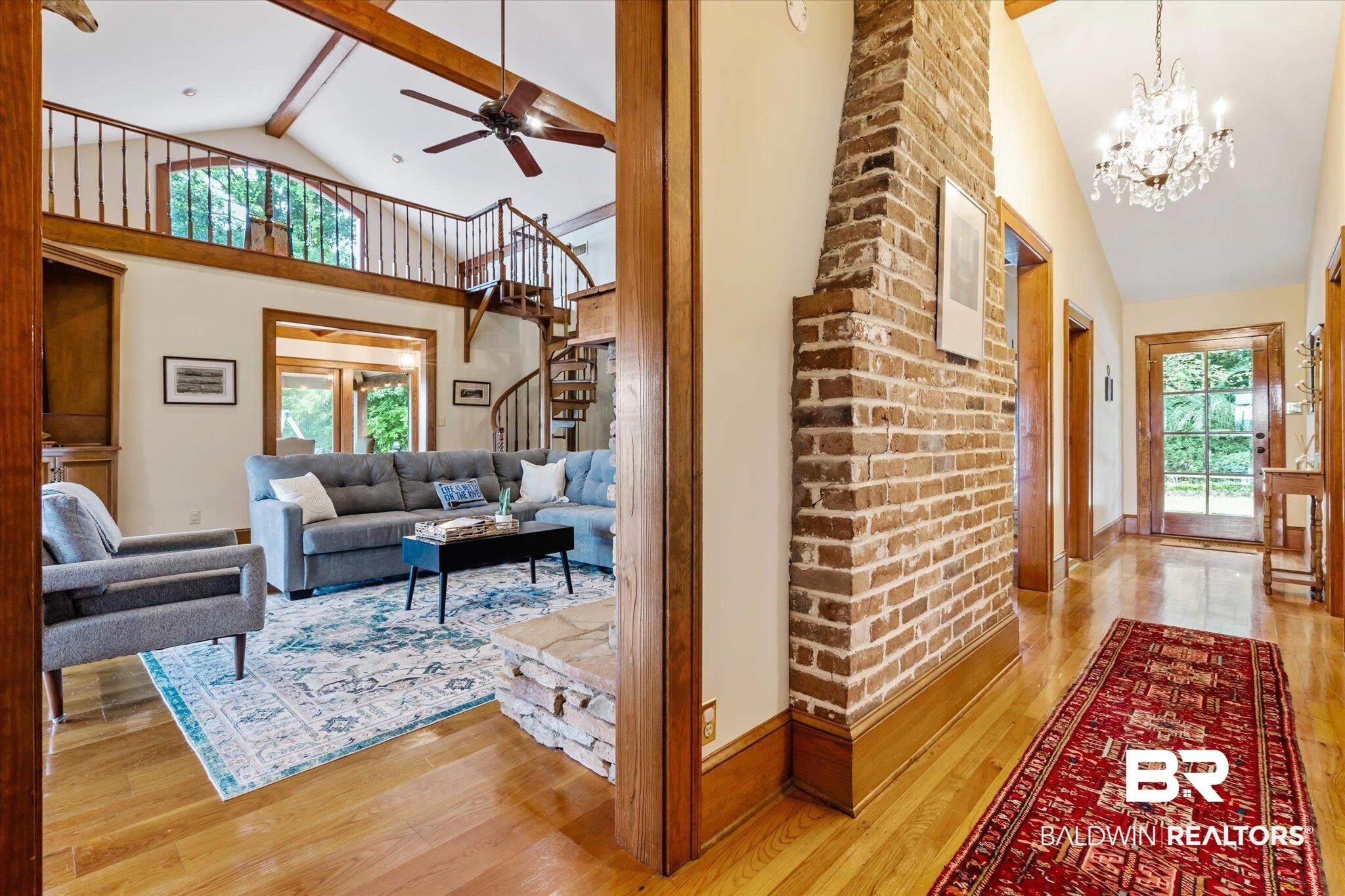 2228 Riverside Drive Mobile, AL 36605 - Photo 20 of 51 Living room with a healthy amount of sunlight, ceiling fan with notable chandelier, high vaulted ceiling, and light hardwood / wood-style floors