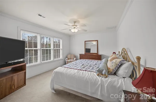 an empty room with a ceiling fan and a window