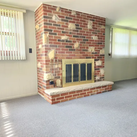 a view of an empty room with a fireplace