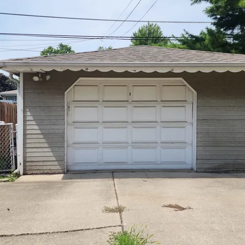 a front view of house with yard and trees