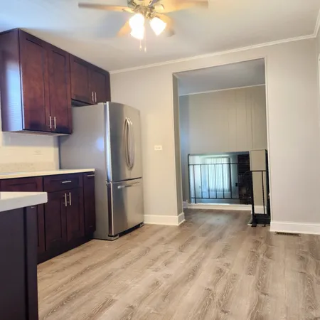a kitchen with a refrigerator and a sink