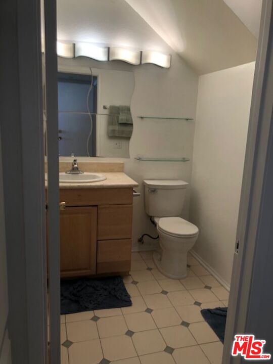 17153 Palisades Circle Pacific Palisades, CA 90272 - Photo 16 of 22 a bathroom with a toilet sink and mirror