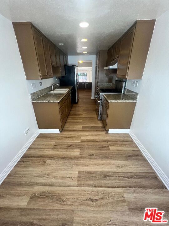 17153 Palisades Circle Pacific Palisades, CA 90272 - Photo 18 of 22 a view of kitchen with microwave refrigerator and cabinets